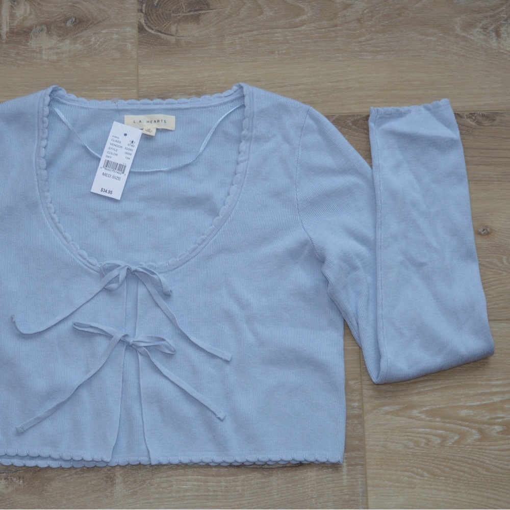Cropped blue long sleeve sweater top.